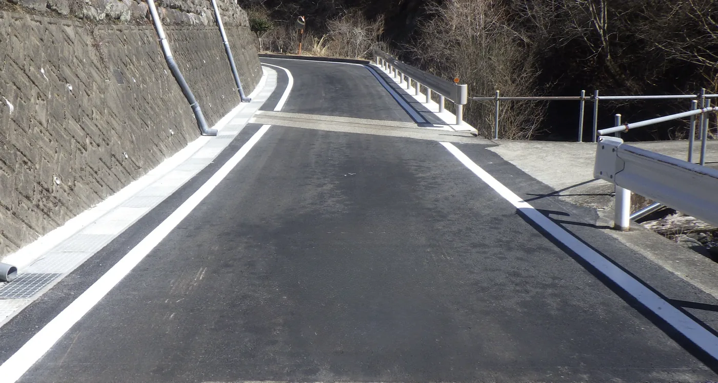 山間の道路で完成したアスファルト舗装と白線